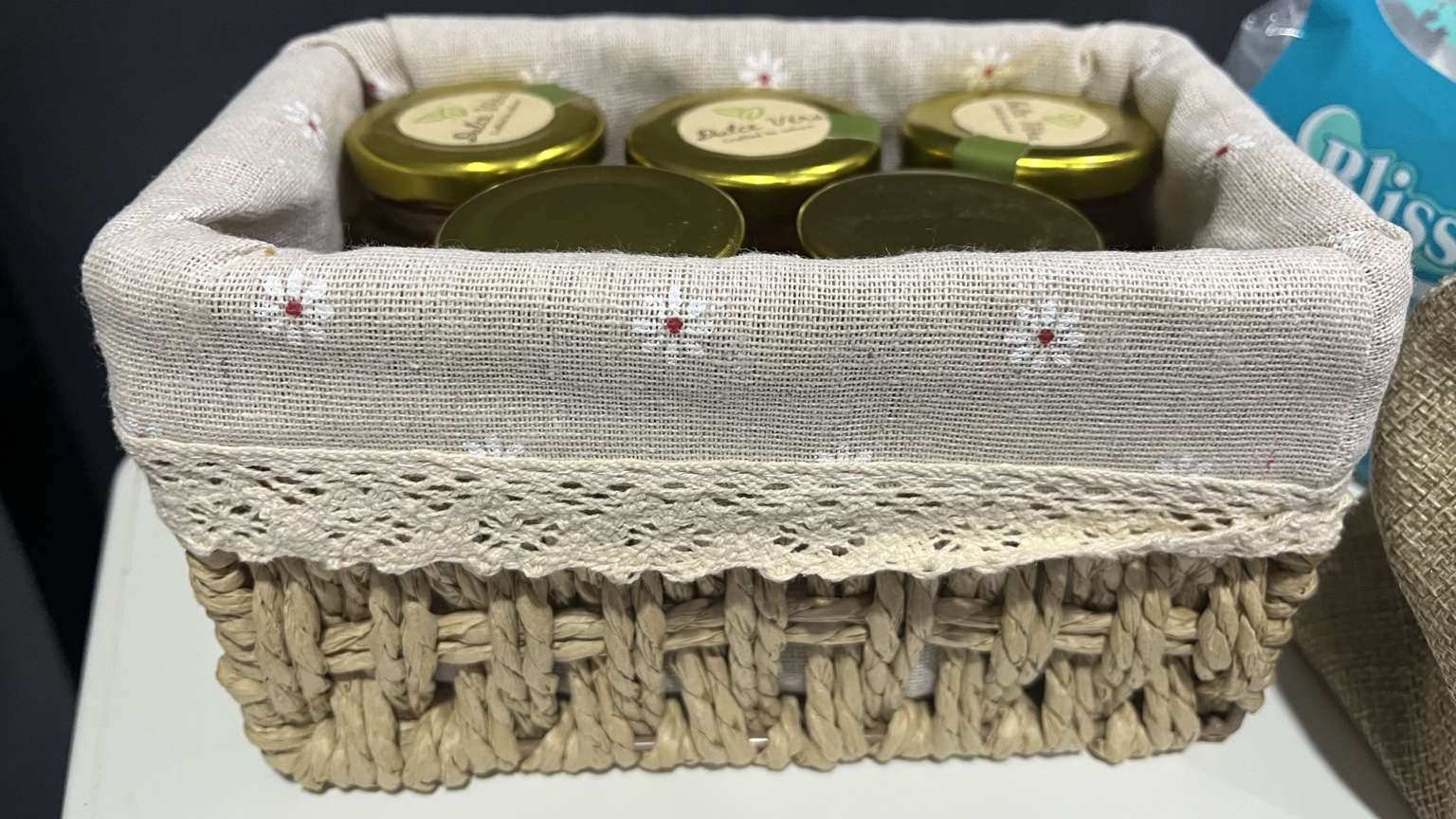 Real basket holding five standing honey jars